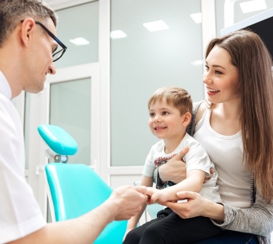 Young boy shaking hands with pediatric dentist