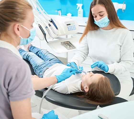 Dentist placing a dental crown in a child’s mouth