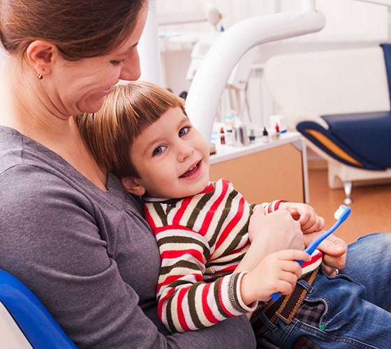 Little boy and his mother at the dentist preparing for dental crowns in Amherst