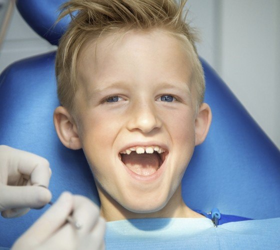 Young boy smiling during dental checkup for kids