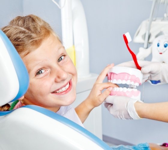 Young boy grinning in dental chair