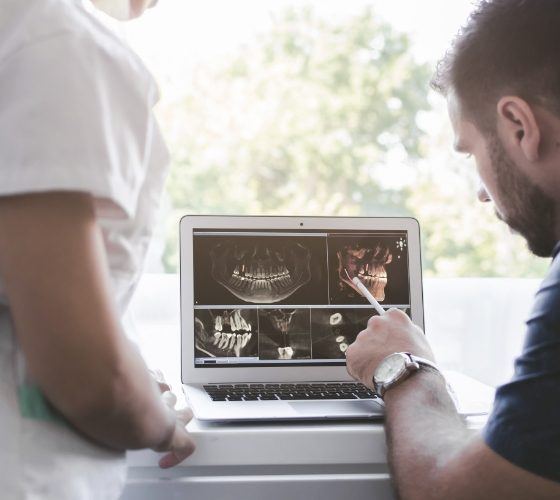 Two dentists looking at dental x rays