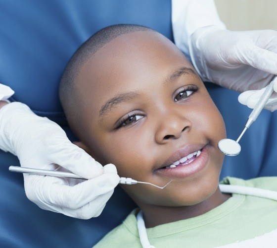 Young boy smiling in dental chair