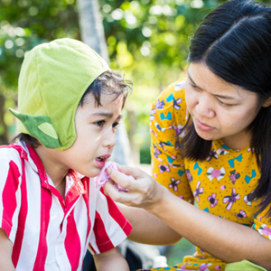 Little boy crying because of mouth pain 