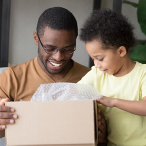 Man and boy opening a box 