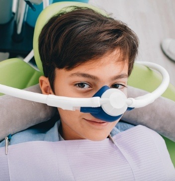 Boy in dental chair wearing sedation dentistry mask