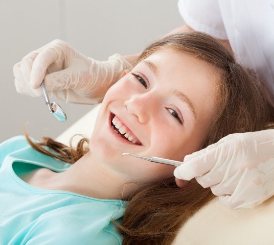 Young child smiling during pediatric dental checkup