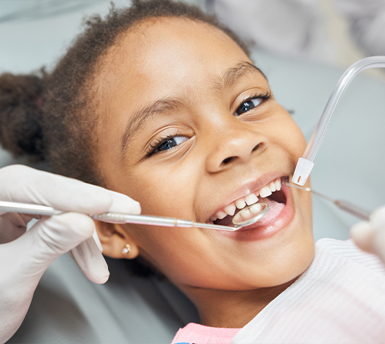 Young girl smiling during preventive dentistry checkup