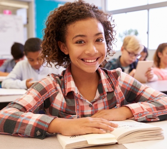 Young girl smiling in classroom