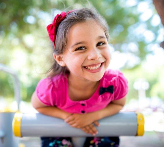 Young girl smiling at playground
