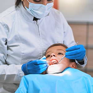 Child undergoing an oral cancer screening
