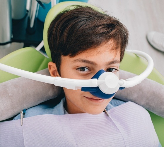 Young boy wearing nose mask for nitrous oxide sedation dentistry