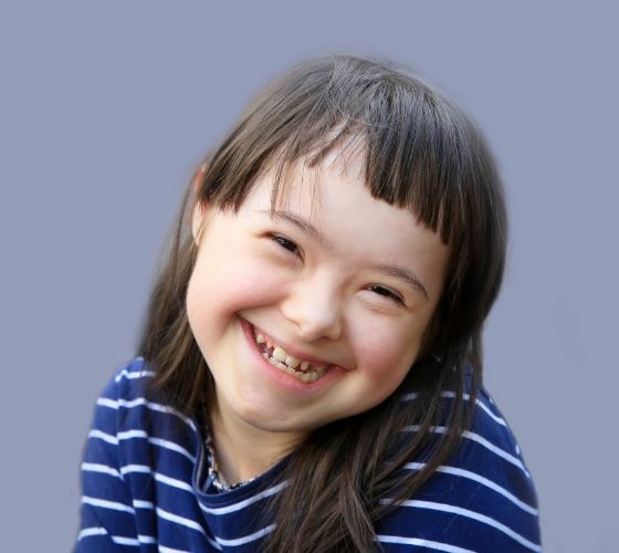 Young girl in blue shirt smiling
