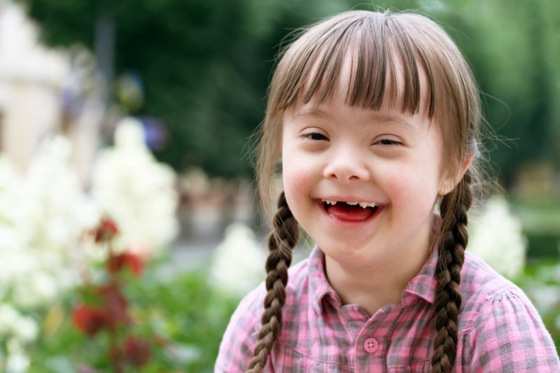 young girl with Down Syndrome smiling