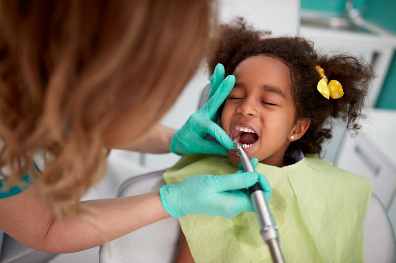 little girl having her teeth cleaned