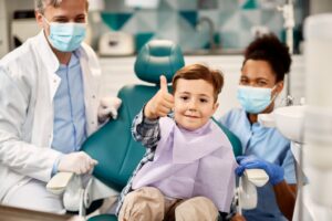 little boy giving a thumbs up